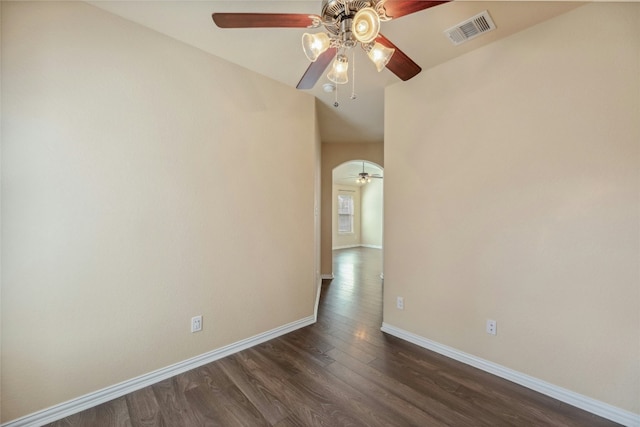 empty room with dark wood-type flooring and ceiling fan