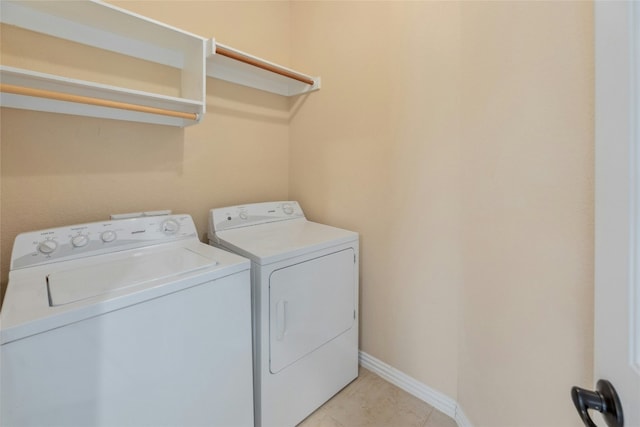 laundry room with washing machine and dryer and light tile patterned floors