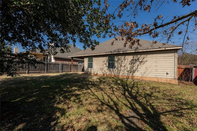 back of house with a yard