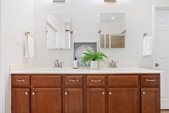 bathroom with vanity and a shower with door