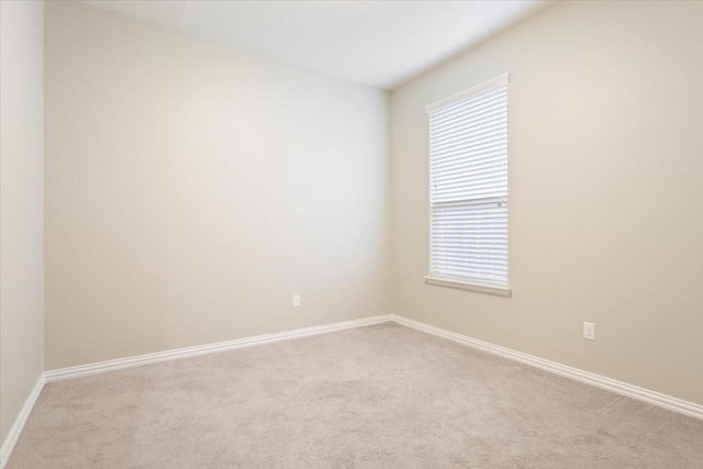 carpeted empty room with a healthy amount of sunlight