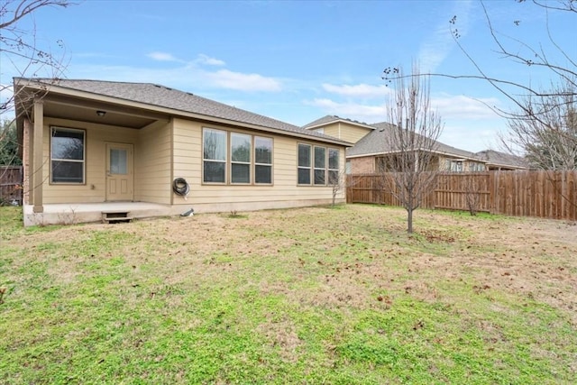 back of property with a patio and a lawn