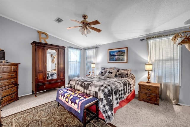 bedroom with ceiling fan, carpet floors, ornamental molding, a textured ceiling, and vaulted ceiling