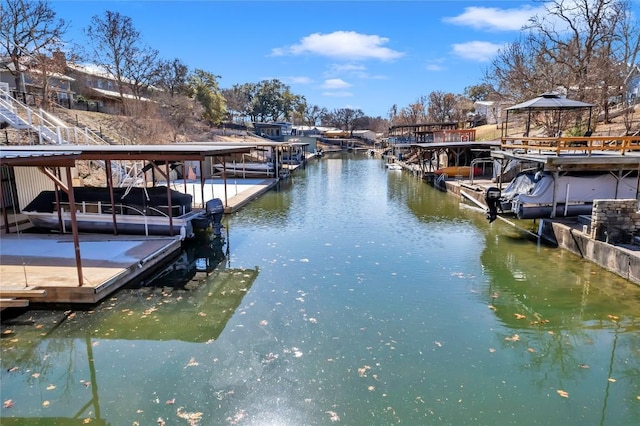 view of dock with a gazebo and a water view