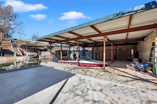 view of patio / terrace featuring a water view and a dock