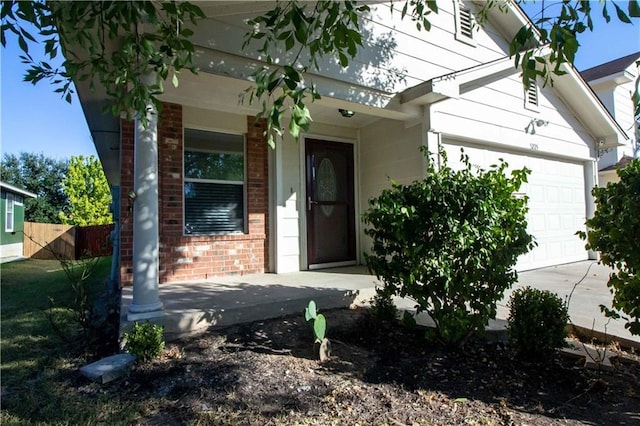 entrance to property with a garage and covered porch