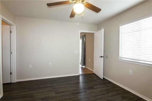 spare room featuring ceiling fan and dark hardwood / wood-style flooring