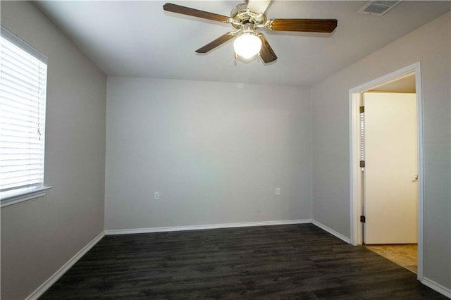 spare room with dark hardwood / wood-style floors and ceiling fan