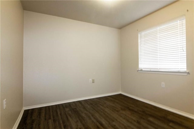 empty room featuring dark wood-type flooring