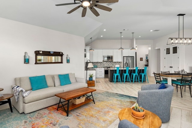 living room featuring ceiling fan and lofted ceiling