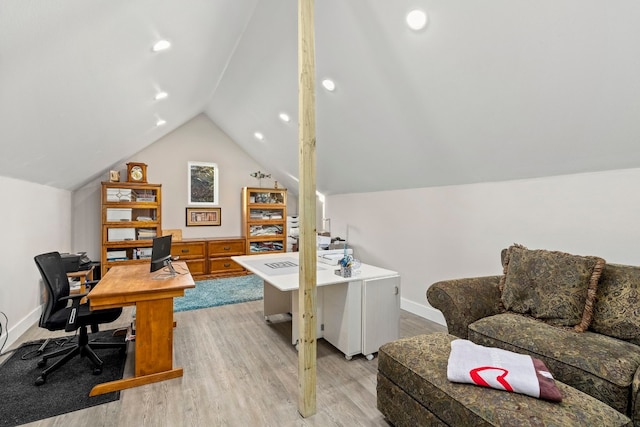 home office with lofted ceiling and light hardwood / wood-style floors