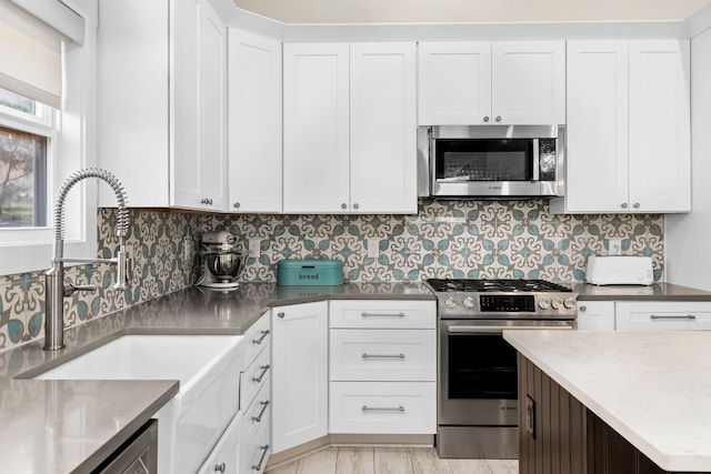 kitchen featuring stainless steel appliances and white cabinets