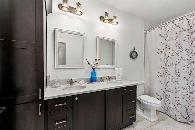 bathroom featuring vanity, toilet, and curtained shower