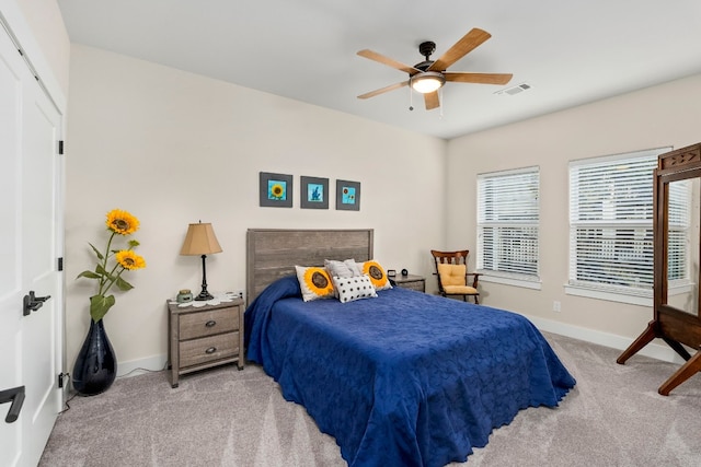 bedroom featuring light colored carpet and ceiling fan