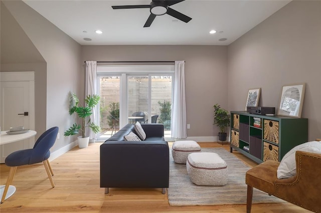 living room with ceiling fan and light wood-type flooring