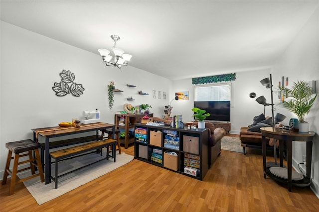 living room featuring hardwood / wood-style flooring and an inviting chandelier