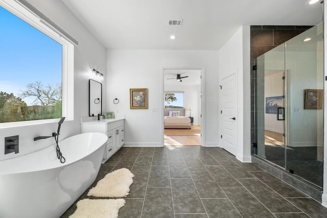 7224 Getaway Dr, Jonestown, TX 78645 - ensuite bathroom featuring vanity, a freestanding tub, ceiling fan, a stall shower, and tile patterned flooring