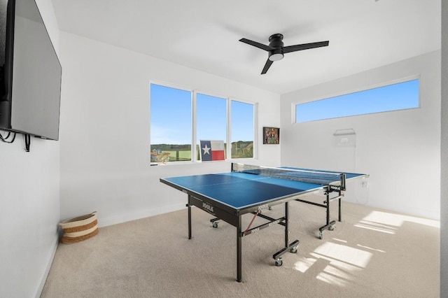 game room with ceiling fan and light carpet