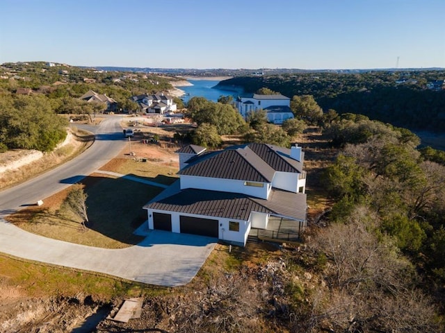 birds eye view of property with a water view