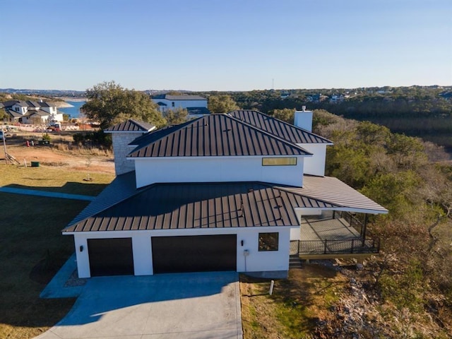 7224 Getaway Dr, Jonestown, TX 78645 - view of front of home with a standing seam roof, a chimney, and driveway