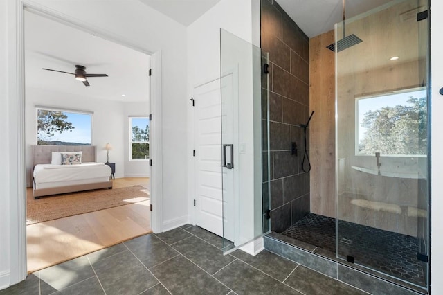 bathroom featuring walk in shower, ceiling fan, and tile patterned floors