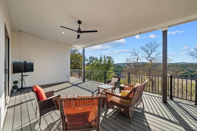 wooden terrace with ceiling fan and outdoor lounge area