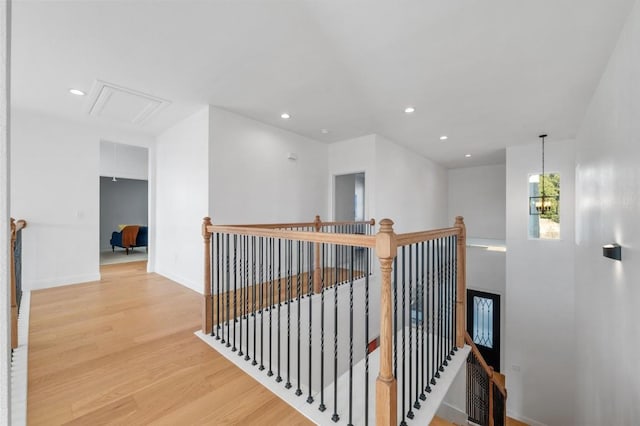 hallway featuring wood-type flooring and a chandelier