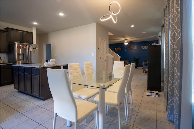 tiled dining area with ceiling fan