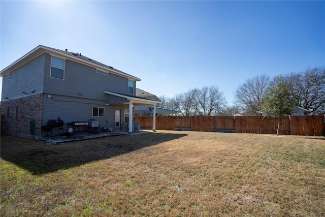 back of property featuring a patio area and a lawn