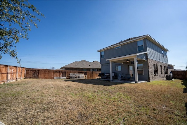 back of property featuring a yard, central AC, and a patio