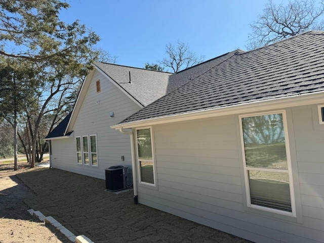 240 Shadow Oak Dr, Bastrop, TX 78602 - back of house featuring a shingled roof and central air condition unit