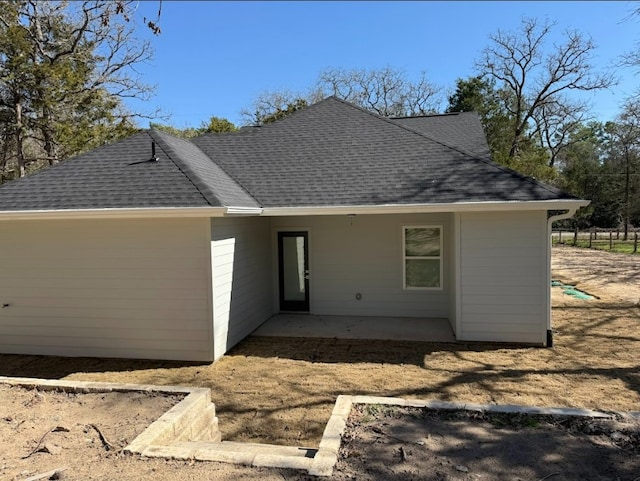 240 Shadow Oak Dr, Bastrop, TX 78602 - back of house featuring a shingled roof and a patio