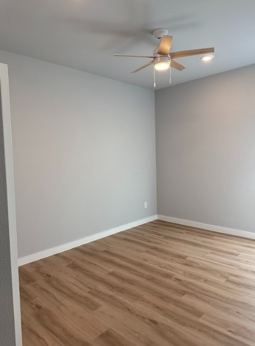 unfurnished room with ceiling fan and light hardwood / wood-style flooring