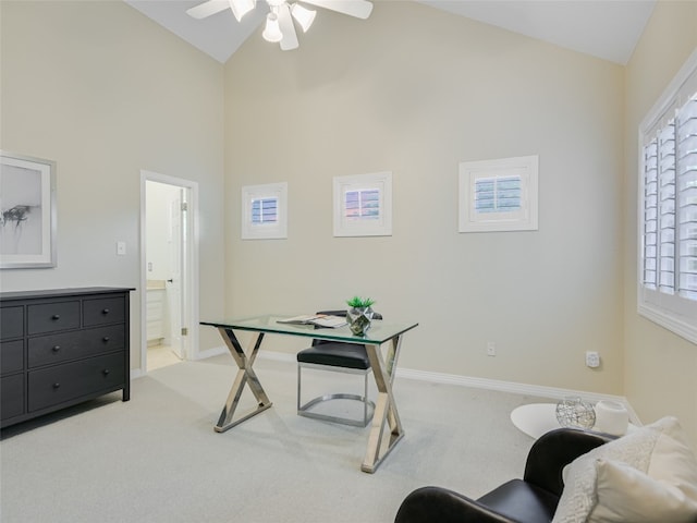 carpeted office featuring baseboards, high vaulted ceiling, and ceiling fan