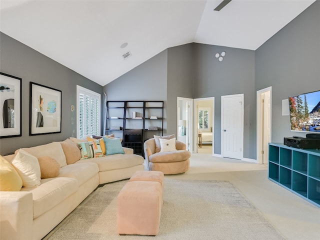 living room featuring high vaulted ceiling, carpet floors, visible vents, and plenty of natural light