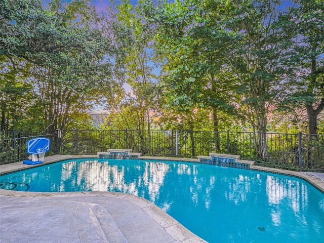 view of swimming pool with fence and a fenced in pool