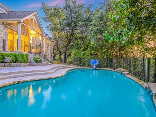 view of swimming pool featuring fence, a fenced in pool, and a patio