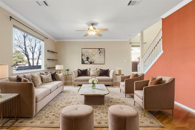 living room featuring ornamental molding, ceiling fan, and light hardwood / wood-style flooring