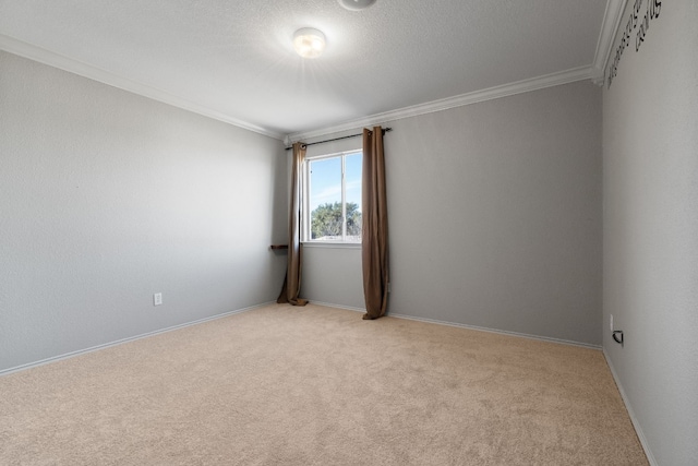 unfurnished room with crown molding, light colored carpet, baseboards, and a textured ceiling