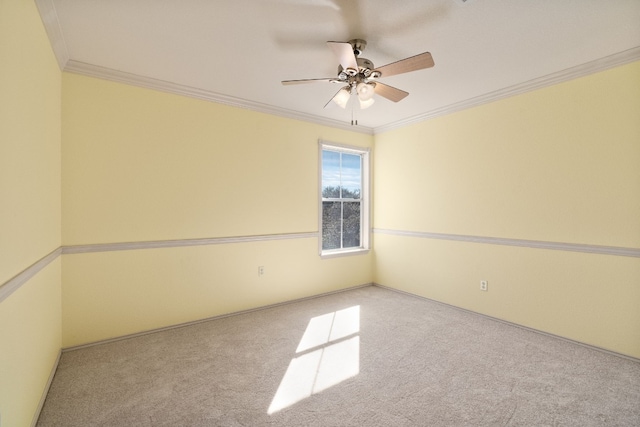 empty room featuring crown molding, light carpet, and ceiling fan