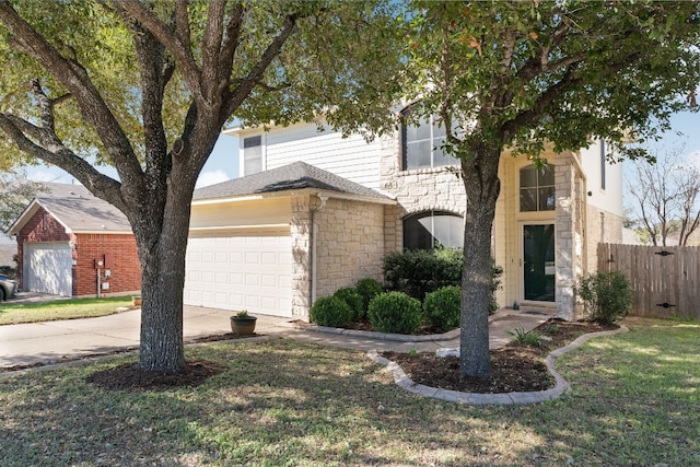 view of front of property with a garage and a front yard