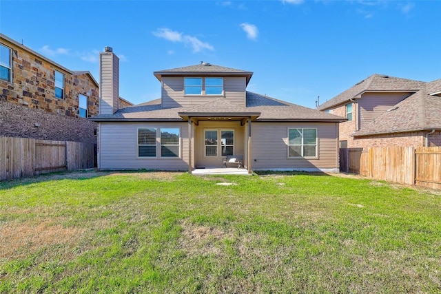 rear view of house featuring a patio and a lawn