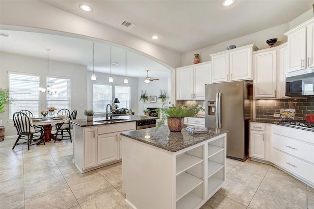 kitchen featuring a kitchen island with sink, sink, white cabinetry, and stainless steel appliances