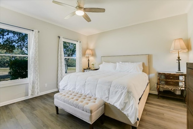 bedroom with hardwood / wood-style flooring and ceiling fan