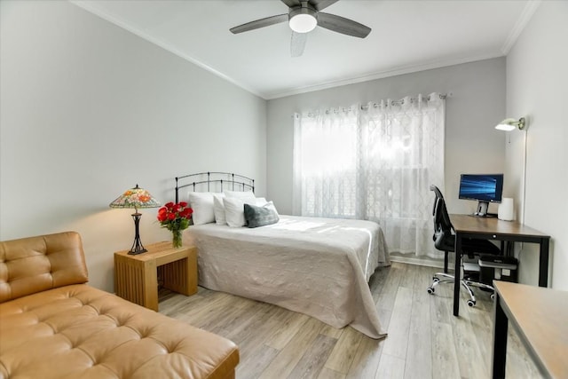 bedroom featuring crown molding, light hardwood / wood-style flooring, and ceiling fan