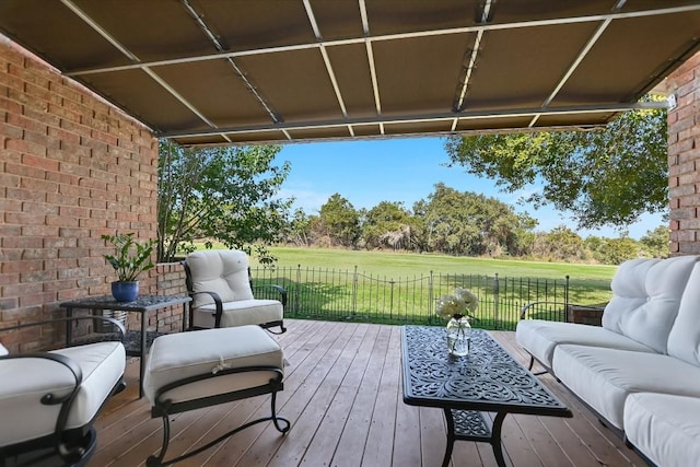 wooden deck featuring a yard and outdoor lounge area