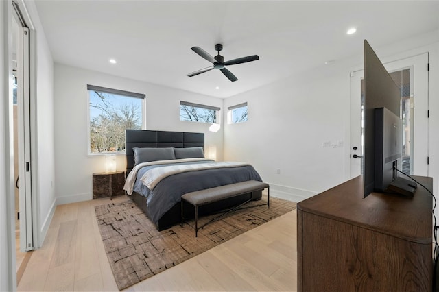 bedroom with ceiling fan and light hardwood / wood-style floors