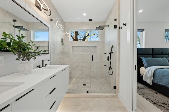 bathroom with vanity and a shower with door