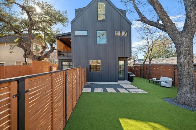 rear view of property with a patio and a yard