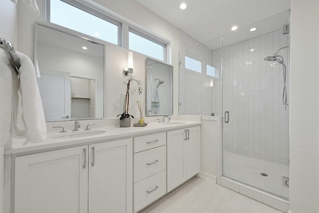 bathroom featuring tile patterned flooring, vanity, and walk in shower